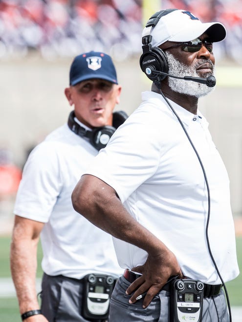 Illinois Head Coach Lovie Smith, right, looks at the score board after Kent State scored a touchdown in the first quarter of an NCAA college football in Champaign, Ill., Saturday, Sept. 1, 2018. (AP Photo/Holly Hart)