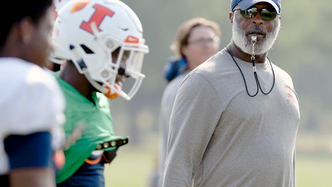 In this Aug. 14, 2018, photo Illinois head football coach Lovie Smith watches his players during training camp at the Campus Rec Fields in Urbana, Ill.