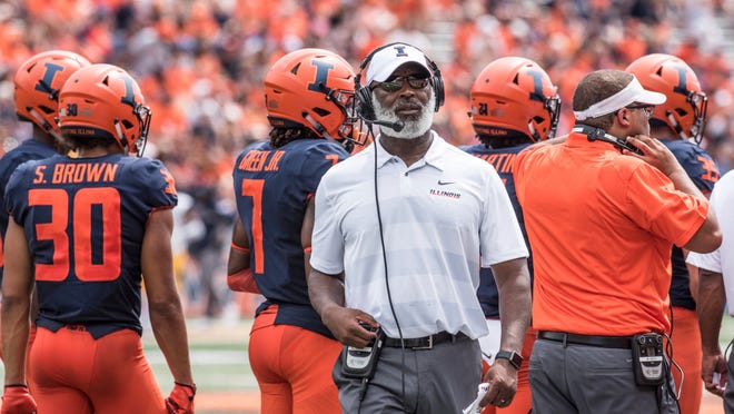 In this Sept. 1, 2018, file photo, Illinois coach Lovie Smith stands near players and coaching staff during the team ' s NCAA college football game against Kent State in Champaign, Ill.