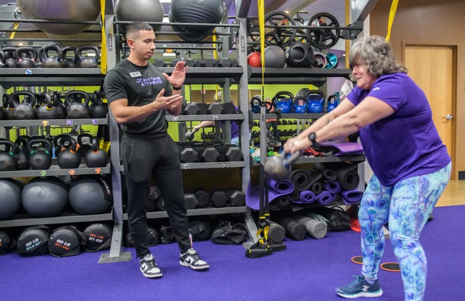 Personal trainer Brandon Crose encourages Maggie Zeman of Peoria Heights in a session at Anytime Fitness, 1320 W. Commerce Drive in Peoria.