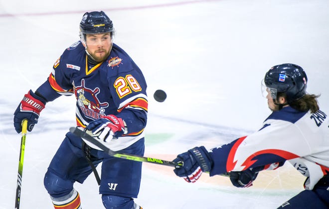 Peoria's Meirs Moore (28) and Evansville's Mark Zhukov try to gain control of a flying puck in the third period of Game 2 of the SPHL President's Cup semifinals Friday, April 19, 2024 at the Peoria Civic Center. The Rivermen advanced to the finals with a 5-2 victory.