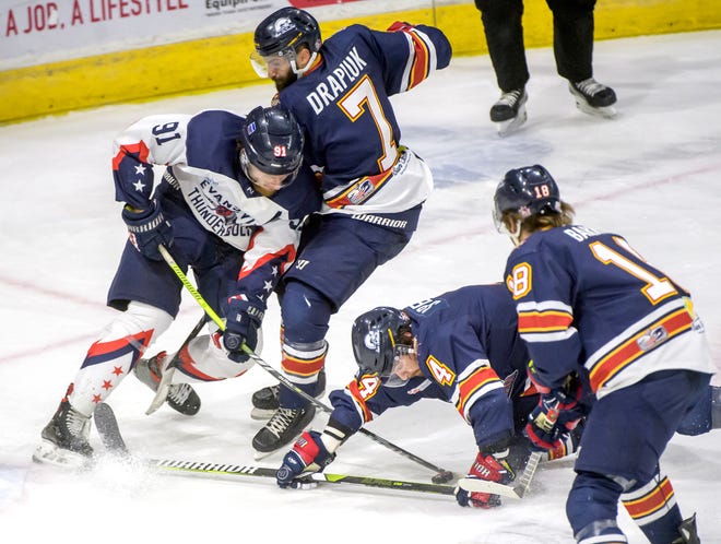 Peoria's Joe Drapluk (7) and Chase Spencer (4) tangle with Evansville's Scott Kirton in the third period of Game 2 of the SPHL President's Cup semifinals Friday, April 19, 2024 at the Peoria Civic Center. The Rivermen advanced to the finals with a 5-2 victory.