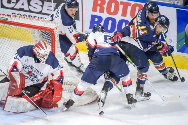 Peoria's Jordan Ernst (11) eye the puck as teammates move in to help against Evansville in the of Game 2 of the SPHL President's Cup semifinals Friday, April 19, 2024 at the Peoria Civic Center. The Rivermen advanced to the finals with a 5-2 win.