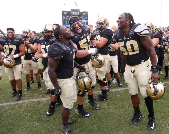 D. J. Knox, from left, Kirk Barron and Keiwan Jones celebrate after Purdue defeated Boston College 30-13 Saturday, September 22, 2018, in Ross-Ade Stadium.