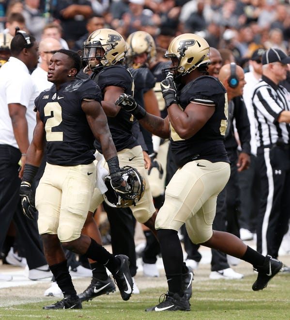 Kenneth Major, left, of Purdue celebrates with teammates after his second half interception against Boston College Saturday, September 22, 2018, in Ross-Ade Stadium. Purdue defeated Boston College 30-13.