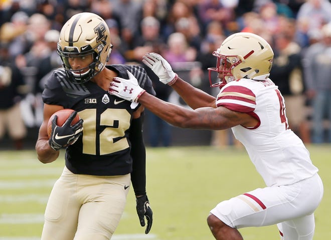 Jared Sparks of Purdue tries to spin free of Hamp Cheevers of Boston College after a pass reception Saturday, September 22, 2018, in Ross-Ade Stadium. Purdue defeated Boston College 30-13.
