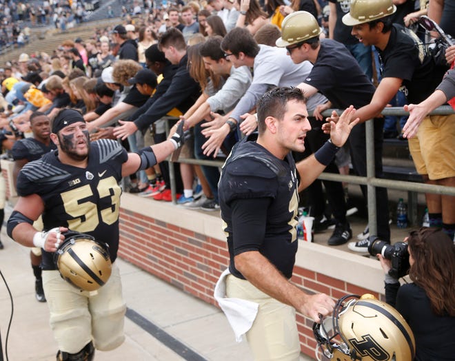 Purdue quarterback David Blough and center Kirk Barron slap hands with the Purdue faithful after the Boilermakers defeated Boston College 30-13 Saturday, September 22, 2018, in Ross-Ade Stadium.