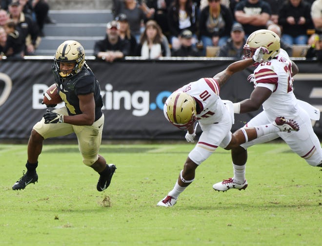 Rondale Moore of Purdue turns the corner on Brandon Sebastian and John Lamot of Boston College on a first half touchdown reception Saturday, September 22, 2018, in Ross-Ade Stadium.