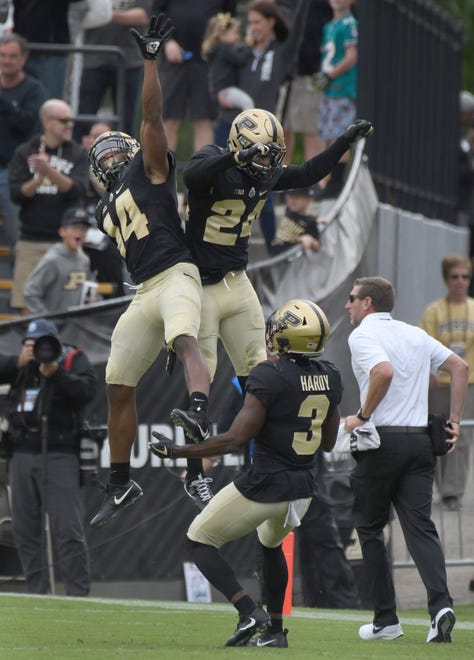 Purdue's Antonio Blackmon, left, celebrates an interception with Tim Cason and Kamal Hardy in Purdue's 30-13 win in West Lafayette on Saturday September 22, 2018.