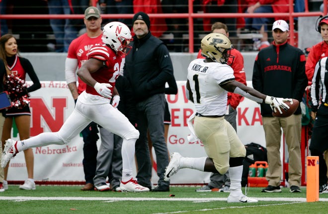 Purdue running back D.J. Knox (1) scores a touchdown ahead of Nebraska defensive back Aaron Williams (24) during the first half of an NCAA college football game in Lincoln, Neb., Saturday, Sept. 29, 2018. (AP Photo/Nati Harnik)