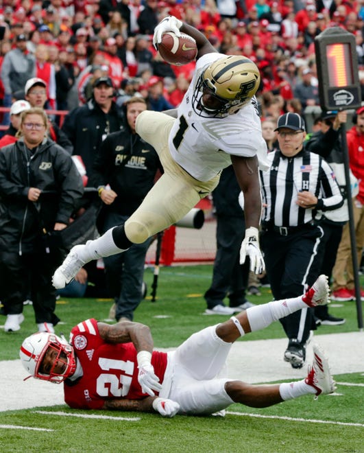 Purdue running back D.J. Knox (1) leaps over Nebraska defensive back Lamar Jackson (21), during the first half of an NCAA college football game in Lincoln, Neb., Saturday, Sept. 29, 2018. (AP Photo/Nati Harnik)