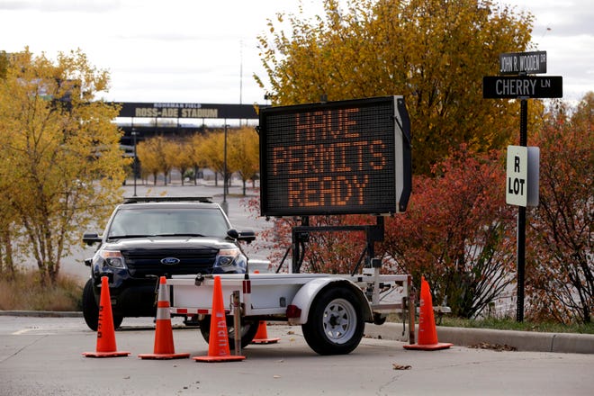 An electronic sign reads "have permits ready" at a parking lot entrance for Purdue University's Ross-Ade Stadium, Saturday, Oct. 24, 2020 in West Lafayette.