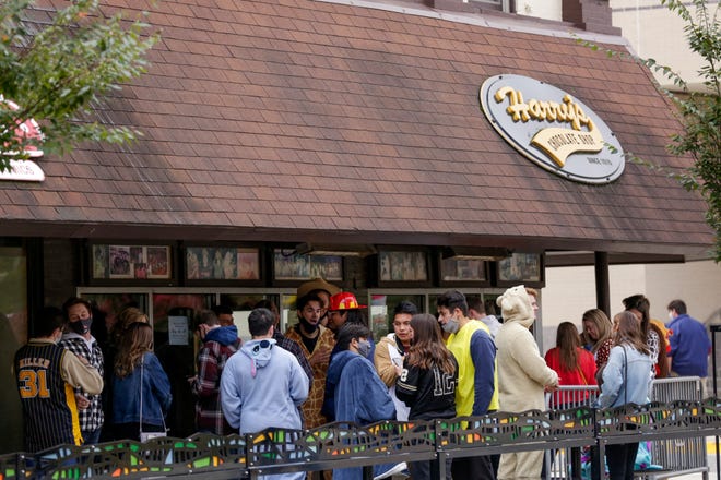Bar-goers line up outside Harry's Chocolate Shop before Purdue University's football game against Iowa, Saturday, Oct. 24, 2020 in West Lafayette.