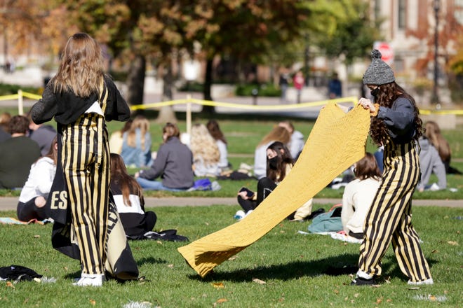 Students place their blankets on the lawn before a watch party on Purdue University's Memorial Mall, Saturday, Oct. 24, 2020 in West Lafayette.
