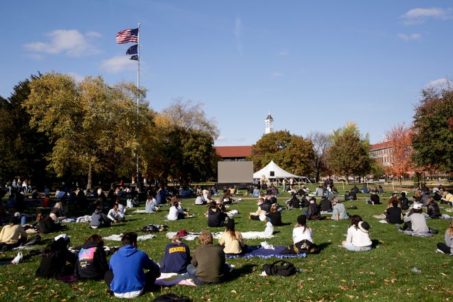Students sit spaced out on the Purdue University Memorial Mall for a watch party for the Boilermakers football game against the Iowa Hawkeyes, Saturday, Oct. 24, 2020 in West Lafayette.