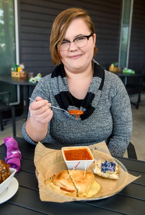 Cassidy Waigand, food and dining reporter for the Peoria Journal Star, enjoying a grilled cheese sandwich and tomato-basil soup at Cyd's in the Park in Peoria.