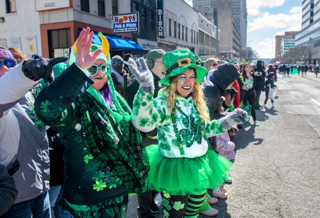 Dressed to the nines in their best St. Patrick's Day gear, Angie Hardin, in the tutu, of Creve Coeur, and Vikki Waldbeesser of Hanna City wave to passing floats during the annual St. Patrick's Day Parade on Friday, March 17, 2023 in downtown Peoria.